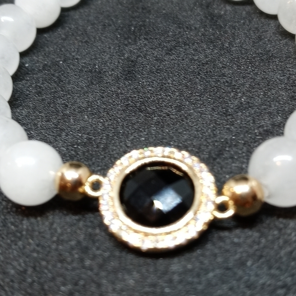 Stretchy Moonstone bracelet with decorative Center and rhinestones.